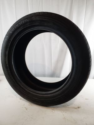 a close up of a tire on a white surface