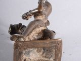 a statue of a man sitting on top of a box
