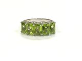 an image of a ring with three green stones