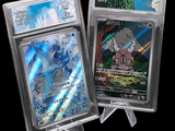 two pokemon cards on display in plastic cases