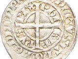 a close up of a coin with a cross on it