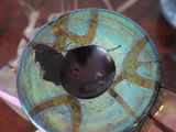 a close up of a metal object with a hole in it