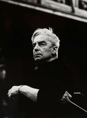 an old black and white photo of a man holding a violin