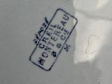 a white plate with a blue and white design on it