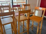 tables and chairs in a room with red walls and a flat screen tv