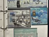 a binder with a picture of a ship and stamps on it
