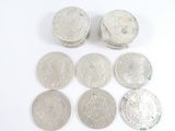 six different types of silver coins on a white surface