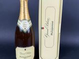 a close up of a bottle of champagne next to a box