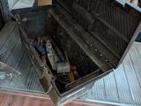 a metal box with tools inside of it on the floor