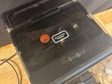 a black toaster sitting on top of a wooden table