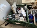 a green container filled with assorted items on a counter