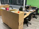 a desk with two chairs and a computer on top of it