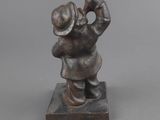 statue of a man with a hat on his head and a hat on his head
