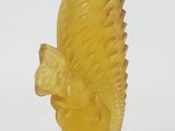 yellow glass figurine of a squirrel on a pedestal