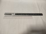 a close up of a ruler on a table with a white sheet of paper