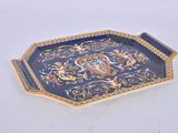 a blue and gold tray with a dragon on it
