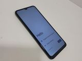 a close up of a phone on a table with a hello button on the screen