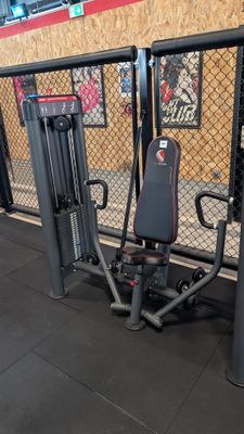 a gym equipment set up in front of a chain link fence