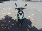 a scooter that is parked on the side of the road