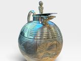 a blue and gold vase sitting on a white surface