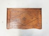 a small wooden box with a design on it