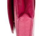 the inside of a pink purse with a gold clasp