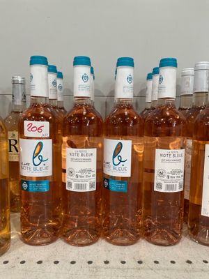 several bottles of wine are lined up on a shelf