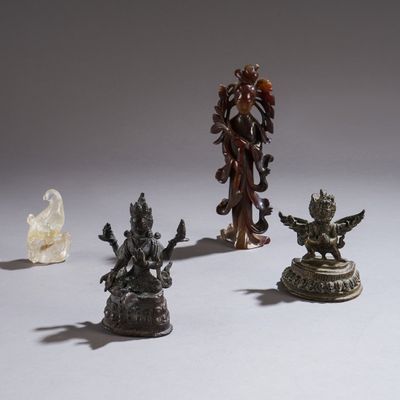 several statues of different shapes and sizes sit on a white surface