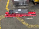 a picture of a red tool box and some tools on the ground