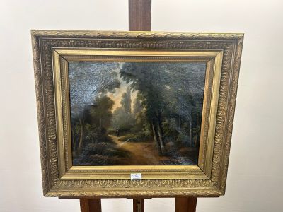 a painting on a easel with a painting of trees in the background