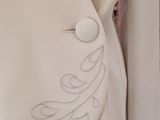 the back of a white jacket with a floral design on it