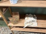 a wooden shelf with a bottle of liquid and a towel on it