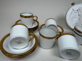 a lot of cups and saucers that are sitting on a table