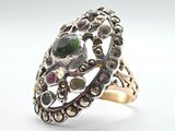 an image of a silver ring with a green stone in the center
