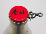 a close up of a bottle with a red cap on it