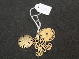 a close up of a gold necklace with a tag on it