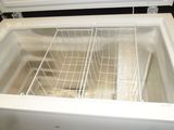 a white refrigerator with a basket inside of it