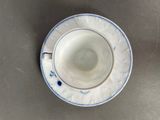 a cup and saucer sitting on a table
