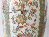 a vase that has a bird and flowers on it