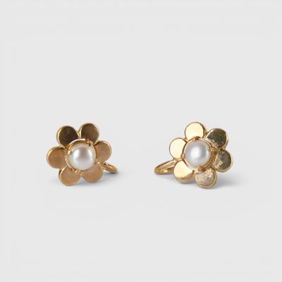 a pair of gold and pearl flower earrings on a white background