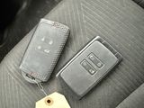 a car key and a keychain on the seat of a car