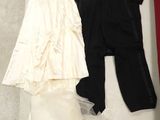 two dresses and a suit on the floor next to each other