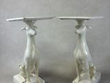 pair of white marble dogs on pedestals with a marble top