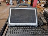 a laptop computer sitting on top of a cart in a garage
