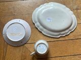 two plates and a bowl on a wooden floor