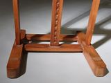 a wooden table with a glass top on a white floor