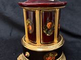a small decorative box with an angel on top of it