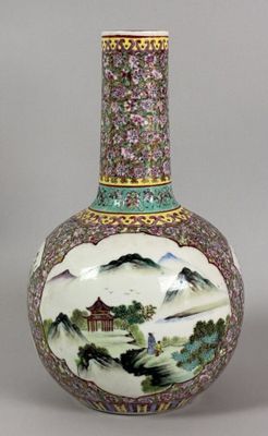 a vase with a painting on it sitting on a table