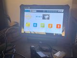 a computer monitor sitting on top of a desk next to a laptop