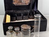 a black case with glass bottles and a brush in it